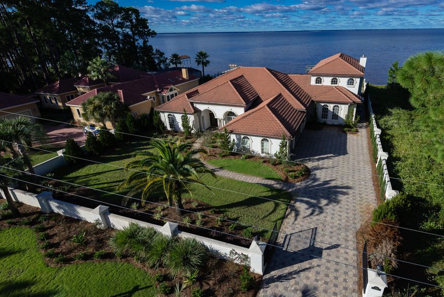 Outstanding price on this just listed 5100+ square foot estate home makes this a must see! This home has been updated in a neutral decor and is move in ready featuring 5 bedrooms, 5 full and 2 half baths, covered pool and a boat dock with lift and seating area. Interior finishes include polished natural stone flooring, custom painted cabinetry with granite tops, inlaid stone and tile work, wine cellar, extensive crown molding, whole house generator and pool heater. If you are looking for your dream home look no further than 220 Shore Drive. Seller is motivated and is ready to go further South.