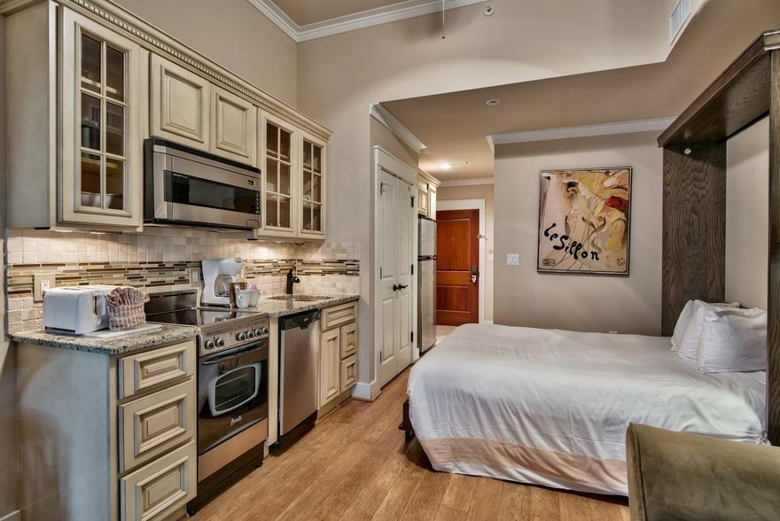 Very unique and modern ground floor studio! The standard kitchenette has been transformed into a full service kitchen complete with a stove, dishwasher, microwave and fridge/freezer combo. Equipped with a modern Murphy style queen size bed, newer furnishings, flat screen television and wood flooring. Enjoy the convenience of a private, fenced in back yard perfect for your four-legged friend. All of these outstanding features have given this property an ''A'' rating on the Sandestin Rental Program. Owners can take advantage of the wonderful amenity terrace which boasts a resort style pool, hot tub, fitness center, and a beautiful lawn with a grilling area. Also enjoy being just steps away from the all the shopping, dining, and activities that The Village of Baytowne Wharf has to offer.