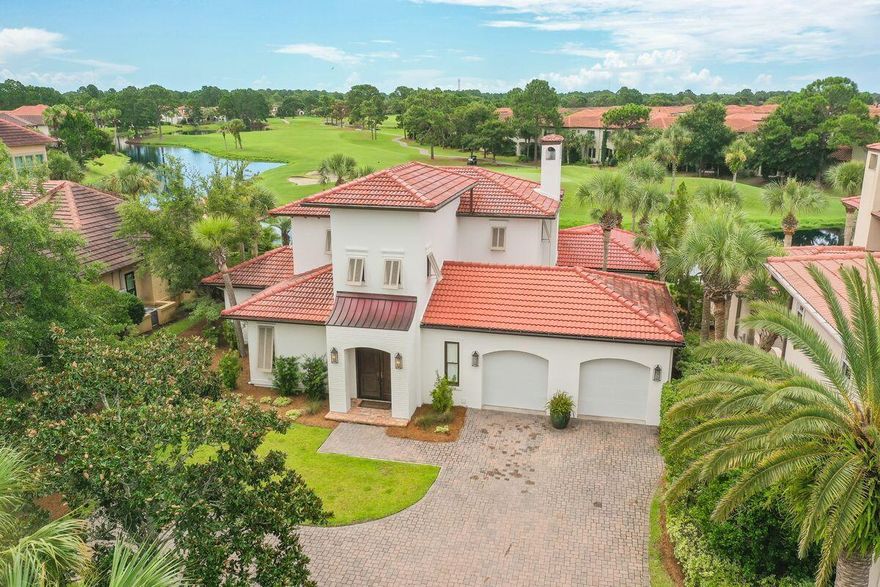 Check out the cool coastal vibe of this Mediterranean style villa in the neighborhood of Del Mar at Sandestin Golf and Beach Resort. It starts with the brick paver entry court with lighted pillars that includes a copper accent roof.  Step into the foyer that makes a statement with 20 foot ceilings, a decorative chandelier and wide plank white oak hardwood floors that flow throughout the entire first floor of the home.  The gourmet kitchen features white quartz counters, subway tiles, a Thermador professional gas range and a Sub Zero glass front refrigerator. The dining area features a contemporary gold accent fixture and French doors leading to a stone paver patio. In the living room, you are greeted with a fireplace with mantle, built in bookshelves