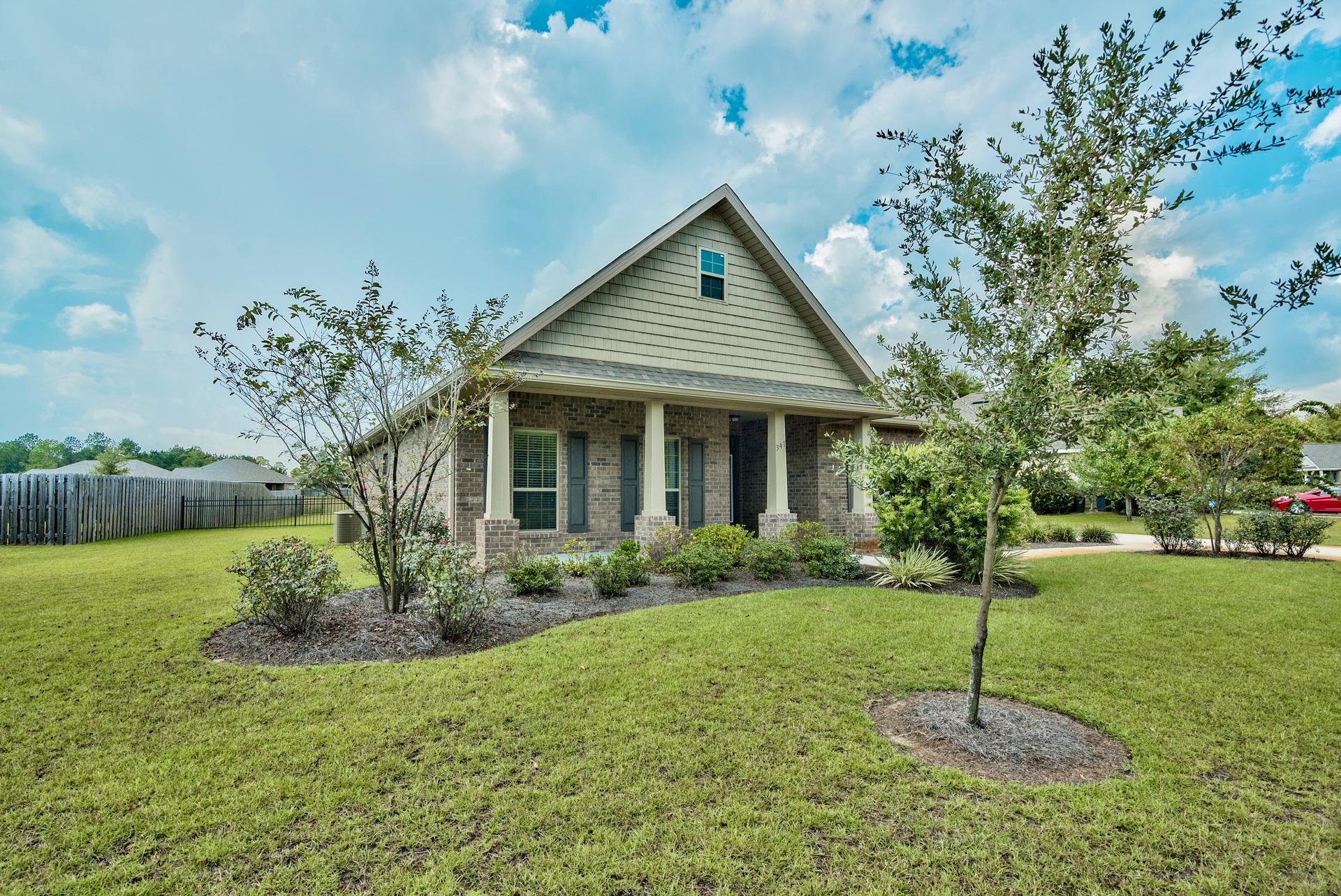 Welcome to this beautiful home in the highly sought-after neighborhood of Hammock Bay. This newly built brick home is located on a quiet loop within the Gardens area of the subdivision and is nestled on a lake, offering a serene environment with views. There is a welcoming entrance complete with curb appeal and nice landscaping.Arched thresholds, vaulted ceilings, & hardwood flooring are just a few of the many features that make this home special. The open living area features a grand vaulted ceiling and access to the office space. A wall of windows in the rear of the home floods the living space with natural lighting. The spacious kitchen has a convenient breakfast bar, granite countertops, and recessed lighting along with lovely wood cabinets and stainless steel appliances.