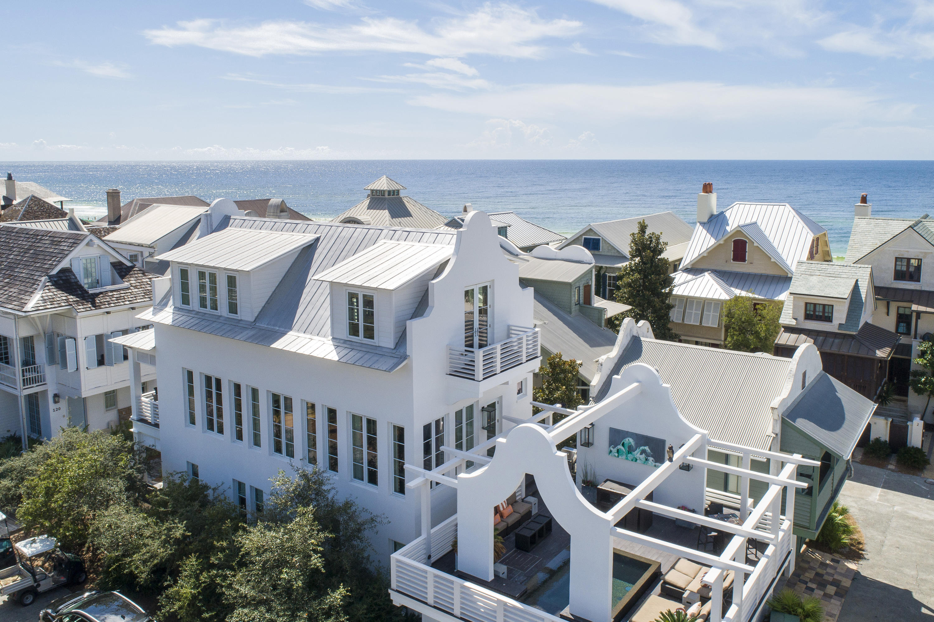 This iconic ROSEMARY BEACH home was originally featured on HGTV and was designed and built by VERN YIP of TRADING SPACES fame, along with architect Frank Green. The home was recently updated by the talented designer Melanie Turner of Atlanta with all NEW HARDWOODS and FURNISHINGS. Located just STEPS from the Rosemary Beach TOWN CENTER and the white sand BEACHES of the Emerald Coast with amazing gulf views.  The home features dazzling CITY VIEWS as well, including The Pearl Hotel clock tower, which can be taken in from the WALL OF WINDOWS that spread across the SECOND FLOOR LIVING AREA. The uniqueness of this home is found throughout the architectural details and the one of a kind SECOND FLOOR INFINITY POOL.  This is the only home in Rosemary that possesses this feature. This home is a favorite for many guest and it will not disappoint.  From the boardwalk which leads straight to the beach, you enter through double glass doors into the foyer. The FIRST FLOOR includes 3 large BEDROOMS, 3 FULL BATHS and a HALLWAY SET OF BUNK BEDS with farm door closure. There is a small patio overlooking the boardwalk, laundry and several storage closets on this floor as well.  Climb the staircase and you will ascend to the LIVING FLOOR which is open concept with large FAMILY ROOM, DINING ROOM, SITTING AREA and ISLAND KITCHEN. There is a FULL BATH, large front BALCONY with gorgeous GULF VIEWS as well as the door that leads you to the incredible SECOND FLOOR POOL DECK. The THIRD FLOOR is a private MASTER RETREAT complete with wall of windows overlooking the gulf, two balconies, laundry, huge closet and executive master bath with soaking tub and large walk in shower.  This home is featured as part of the Rosemary Beach Cottage Rental Luxury Collection and is a favorite rental for many.  With rental projections of approximately $275,000 a year this home will serve as a great investment property as well as a family retreat.  
