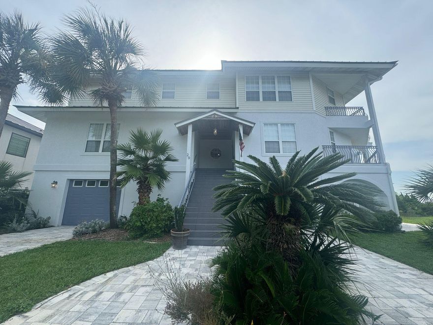 Custom 3-Story Home with Stunning Bay Views. This unique home offers breathtaking views of the bay from multiple balconies and a patio, along with private bay access and a community dock, with its own slip and two jet ski floats, just a short trip to the sugar sand and emerald waters at the beach -- perfect for water enthusiasts. The property is filled with custom features and provides plenty of privacy. Each floor features a bedroom, offering versatile living arrangements. The third floor boasts a luxurious primary suite with panoramic bay views, a separate office area overlooking the water and complete with balcony, and a spa-like primary en suite with separate double vanity, a walk-in tiled shower,