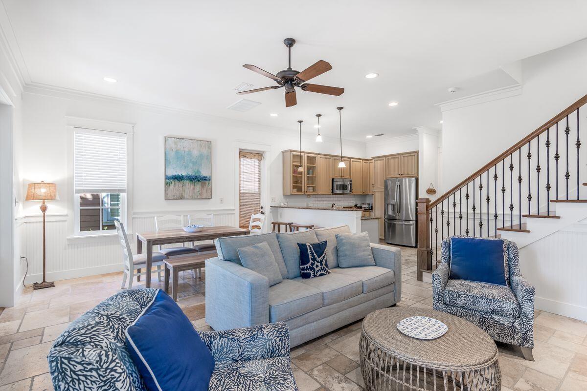 Set back with an expansive driveway, this home is the epitome of a Florida coastal cottage. Sold furnished with 6-seater golf cart. The deep screened front porch invites outdoor living and the opportunity to relax and dine alfresco. Double French doors open into the light living room with travertine flooring and coastal chic furnishings. Daylight softly filters through multiple windows and the earthy palette of creams and browns completes the restful ambience. The natural color scheme continues into the kitchen with granite counters, cabinets with under cabinet touch lighting, stainless appliances, and subway tile backsplash. The dining and living area deliver a perfect set up for entertaining with a gas fireplace, custom built in wine color and separate beverage cooler, and half bath.
