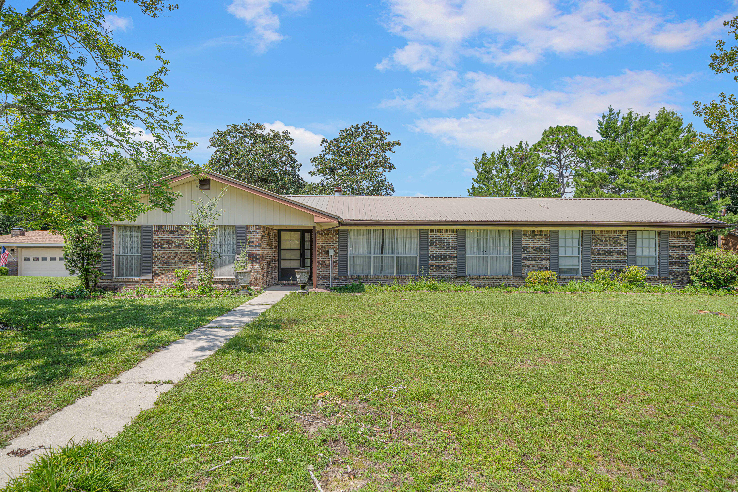Have you heard the saying ''good bones''? Well this all brick home has lots of potential. Original owners have enjoyed this home for many years. It does need some updating but it has a great floor plan, good location, large corner lot and metal roof. Open floor plan with kitchen and family room. Family room has a wood burning fireplace. Separate living room & dining room. Great extra spaces that could be used as flex room for playroom, office, gaming are etc. Enclosed 26x12 Florida Room for watching nature in the backyard. Patio for outdoor grilling. Sprinkler system, large corner lot. Bedrooms have good sized closets. Master bath has double vanity. Garage is extra large with double sink by washer/dryer area. Come see it today!