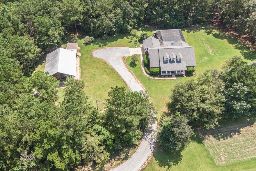 BEAUTIFUL CUSTOM HOME sitting on 5 ACRES with a 40x48 unenclosed Pole Barn built with 2x12 supports and 26 gauge metal with 12 1/2 feet of clearance for boats and RV's etc.  This home has everything you could desire.  Three bedrooms and two baths down stairs and two large bedrooms,  large den and bath upstairs.  The family room downstairs has a custom gas fireplace with mantle.  It has french doors that open up to the Gunite Salt Water Pool with metal screen enclosure, and rock waterfall.  Making this home perfect for entertaining.  The master suite is large and opens to a large master bath with a jacuzzi tub for relaxing and separate shower.  Composite floors with tile were downstairs for easy maintenance.   Insurance is low due to the HVAC is less than a year old and it has a NEW ROOF.