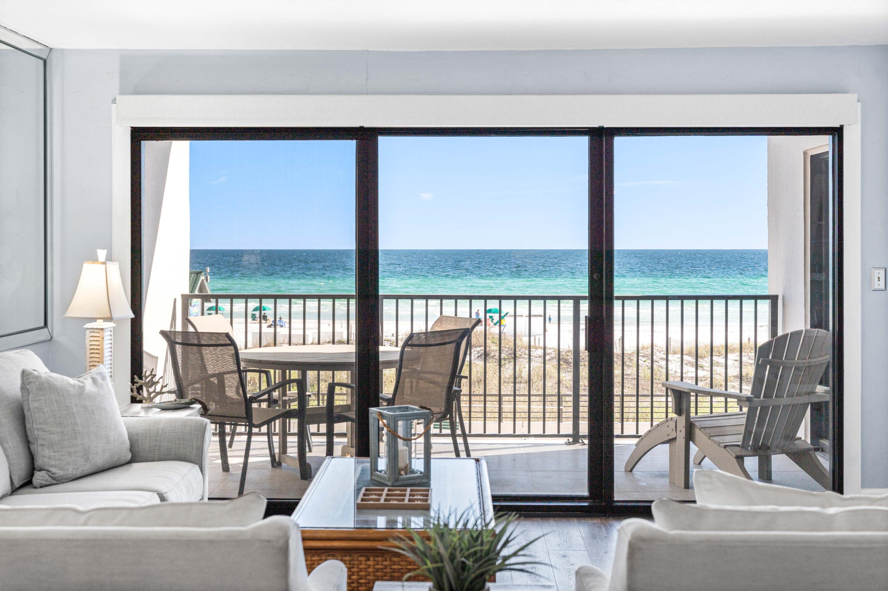 Luxurious Gulf-front unit available in the private, gated condominium of Emerald Towers, highly coveted for its breathtaking panoramic views of the azure Gulf waters and pristine white sandy beach from its second-floor vantage point. This stunning unit has undergone a complete renovation, boasting a modern kitchen equipped with sleek stainless steel appliances including an oven with a built-in air fryer, quartz countertops, a stylish tile backsplash, custom illuminated cabinetry, a convenient wine cooler, pantry, and a bar with an ice maker. Laundry needs are met with ease thanks to the stacked LG washer and dryer tucked away in a closet and the hot water heater was replaced last yea. A stunning view of the turquoise waters of the gulf provides a backdrop for the kitchen (Continued) dining room and living areas. Remote-controlled power window shades adorn the living area, adding convenience, ease, and sophistication to the space. The primary bedroom exudes comfort with its plush king-sized bed, plantation shutters, and direct access to the balcony, offering a tranquil retreat. The primary bathroom even has a built-in linen closet providing ample storage space, alongside a walk-in shower. The spacious second bedroom and the adjacent bathroom provides a retreat for guests after a fun day at the beach. This condo is truly a turnkey oasis. Residents of Emerald Towers enjoy access to an array of amenities, including a seasonally heated pool, tennis and pickleball courts, and a well-equipped exercise room featuring a sauna and steam shower for relaxation and rejuvenation. This unit is sold fully furnished, ensuring immediate enjoyment of the Emerald Towers lifestyle. Additionally, the entire exterior of Emerald Towers underwent a comprehensive restoration in 2022, further enhancing its appeal and longevity.