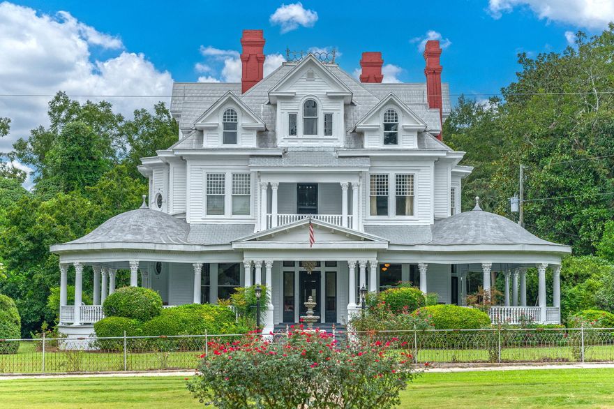 1910 Queen Anne masterpiece with 95% original splendor still intact. Magnificent 16-room estate greets you with rare Curley-pine wainscoting adorning most of downstairs along with Hand-crafted curly-pine columns and trim that adds unmatched level of craftsmanship. Spanning 5640 sqft of living space offering 5 BR, 2 1/2 BA, with selections of rooms designed to transport you back intime. Renovated kitchen includes 2 sinks, a Viking gas stove, 9 ft center island and connects to butler panty. Fireplace enthusiasts will appreciate 9 fireplaces with 5 showcasing mahogany mantles, the remaining 4 feature ornate painted mantles. Outdoor amenities include a covered pool house with shower, powder room, inground pool surrounded by brick paver coping. This grandeur comes with a 42 month home warranty The estate boasts a carriage house, a screened summer kitchen, barn, and a storage shed. The grounds include fountains and lily pools. Experience the grandeur and timeless elegance of this Florala gem for yourself.
