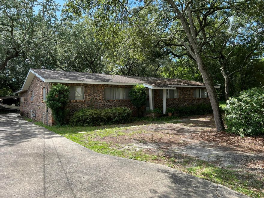 Opportunity is knocking!  All brick home on 1/3 acre lot with a 800+ sf detached garage/shop. Sitting among old oaks and mature azaleas, this home has a comfortable floor plan with a large inside laundry room and a huge kitchen with three walls of cabinets and counter space! The detached garage/shop has garage door access from either end and is ready for your vehicles, toys or projects. So much potential! Conveniently located between both bases and ready for your remodeling ideas and updates!