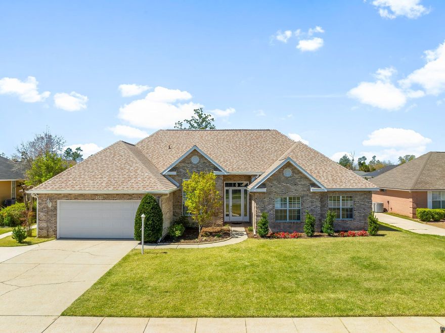 Welcome home to this stunning all-brick residence in The Woods subdivision--perfectly positioned in the heart of Panama City! With shopping, dining, and top medical facilities just minutes away, including a quick 7-minute drive to Publix in SweetBay, convenience is at your doorstep. From the moment you step inside, you'll be captivated by the soaring cathedral ceilings in the family room, enhanced by dormer lights and a bank of windows that flood the space with natural light and offer picturesque views of the professionally landscaped backyard. The electric fireplace creates a warm and inviting focal point, perfect for cozy nights in. The sprawling 16.6' x 20.6' eat-in kitchen is a chef's dream, featuring a kitchen island, breakfast bar, and generous cabinet space--ideal for hosting and everyday living. Just off the kitchen, a huge den/family room offers endless possibilities for gatherings, movie nights, or simply unwinding in comfort. The primary suite is a true retreat, complete with his-and-hers walk-in closets, a luxurious whirlpool tub, separate shower, and a cozy alcovethe perfect spot to sip your morning coffee while planning your day. Step outside to your beautifully landscaped, fully fenced backyard, designed for relaxation and entertainment. A screened-in patio provides a serene spot to enjoy the Florida breeze, while a brick outbuilding with power offers endless possibilities for a workshop, home office, or extra storage. Hurricane shutters. Additional highlights include a new roof in December 2018, a spacious two-car garage with ample storage, and a large laundry area conveniently located off the garage. This gorgeous home has so many extras to mention, please schedule your showing to see all the beautiful features of this home.