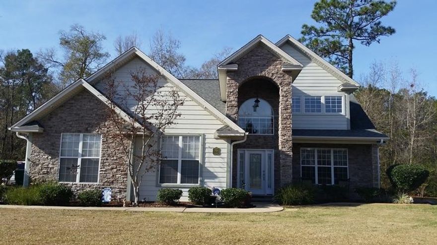 Welcome to the prestigious Juniper Creek Estates. This home is gorgeous with unmatched curb appeal. Right away you notice the grandeur that this home exudes with it's two stories. The exterior is adorned with stone, hardy board and brick. As you walk up to the home you are greeted by a tiled front patio and to the right there is a sitting area. As you step inside the large living area, the cathedral open ceilings invite you in. The living room is large with lots of windows for natural lighting. In the summer you can close the professionally installed insulated window shades to keep the cool in. A beautiful stone fire place creates a natural separation between the living and formal dining area. The kitchen has gorgeous hickory wood cabinetry, granite counters and stainless steel appliances.