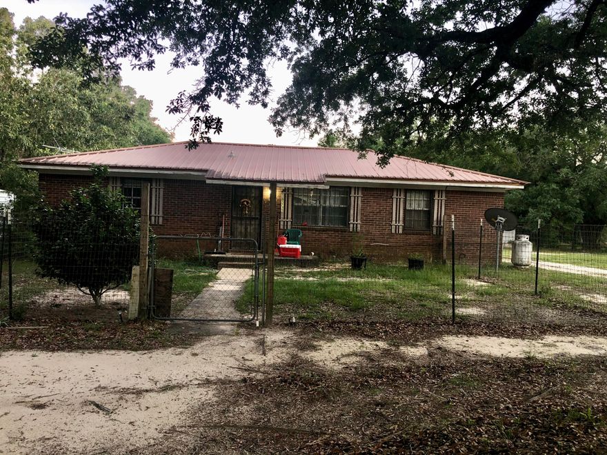Just A Little Bit of Country is what you will find on this property! All brick 3 bedroom, 2 bath, split floor plan just minutes from town on 4.23 acres. Stately Oaks grace the property, with Fig Trees, Pear Trees.There are two pole barns with plenty of room for chickens and other farm animals. Air Conditioning and Heat pump Just Replaced. You have all the privacy and serenity only minutes from town.Being sold AS IS. Buyer to verify sq ft and any pertinent information.