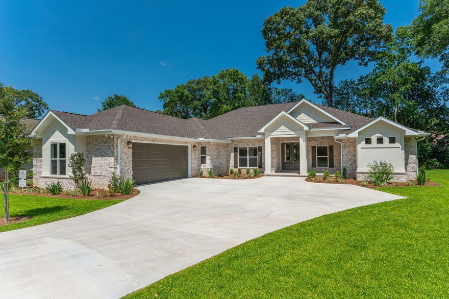 NEW CONSTRUCTION! GatedCommunity! AWARD WINNING BUILDER! OUTDOOR FIREPLACE! This STUNNING home is quality built and loaded with details that are sure to impress. You'll be wowed as soon as you step into the double door entryway. This 4 bd home features an expansive floor plan with amazing flow, tall ceilings, wood beams, 8 ft doors throughout, and a kitchen that is a chef's dream. The massive 12 ft island is the perfect complement to the custom wood range hood that hangs above the 36 inch gas kitchenAid cooktop.. All high end appliances, beautiful lighting, hardwood flooring, French doors leading to the covered rear porch that is complete with a brick wood burning fireplace and a stained tongue and groove ceiling! The master bedroom features tray ceiling, a  trimmed focal wall,