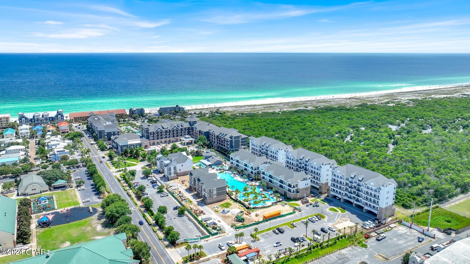 Penthouse Unit Offering elegant resort living in the heart of Destin, this almost brand-new two-bedroom condo is being offered fully furnished and has never been lived in. Designed by award-winning architects Jeff Prescott and Associates, this luxury condo was completed in late 2023. Interior appointments include ten-foot ceilings, solid core doors, high-end fixtures, and impact-rated windows. The coastal decor along with comfortable furniture and tile flooring set the tone for a relaxed beach getaway. Located on the first floor of a four-story building, this pristine unit has nature views from the living room and spacious balcony. A wet bar with refrigerator delivers a steady flow of beverages after a busy day at the beach or golf course.