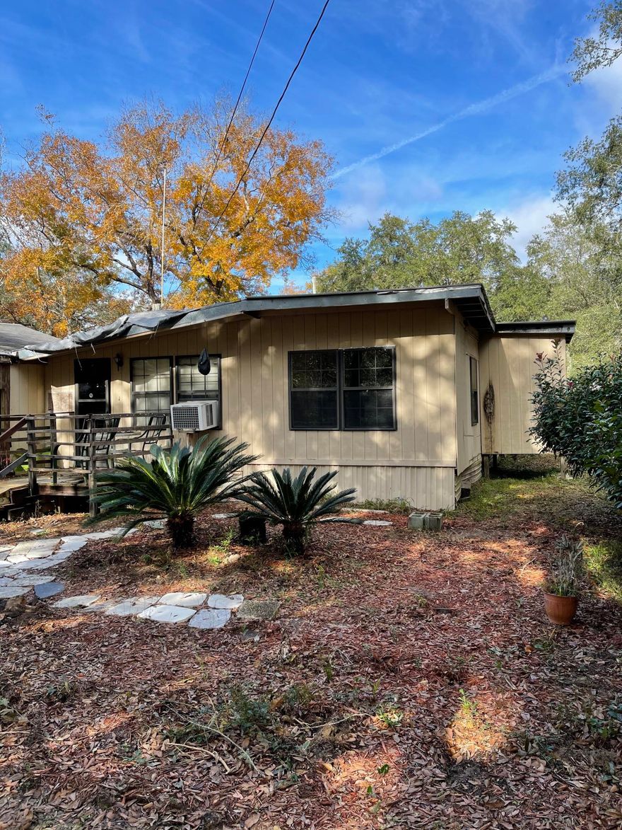 This 1/4 acre property has old mobile home and newer garage and shed and is close to Truett's boat launch. Cash only, AS IS, no survey. Seller makes no warranties on condition of home or septic. The home is on city water. Tear down old mobile and make it your new home or fish camp. Lots of possibilities with base infrastructure in place with no HOA or restrictions.