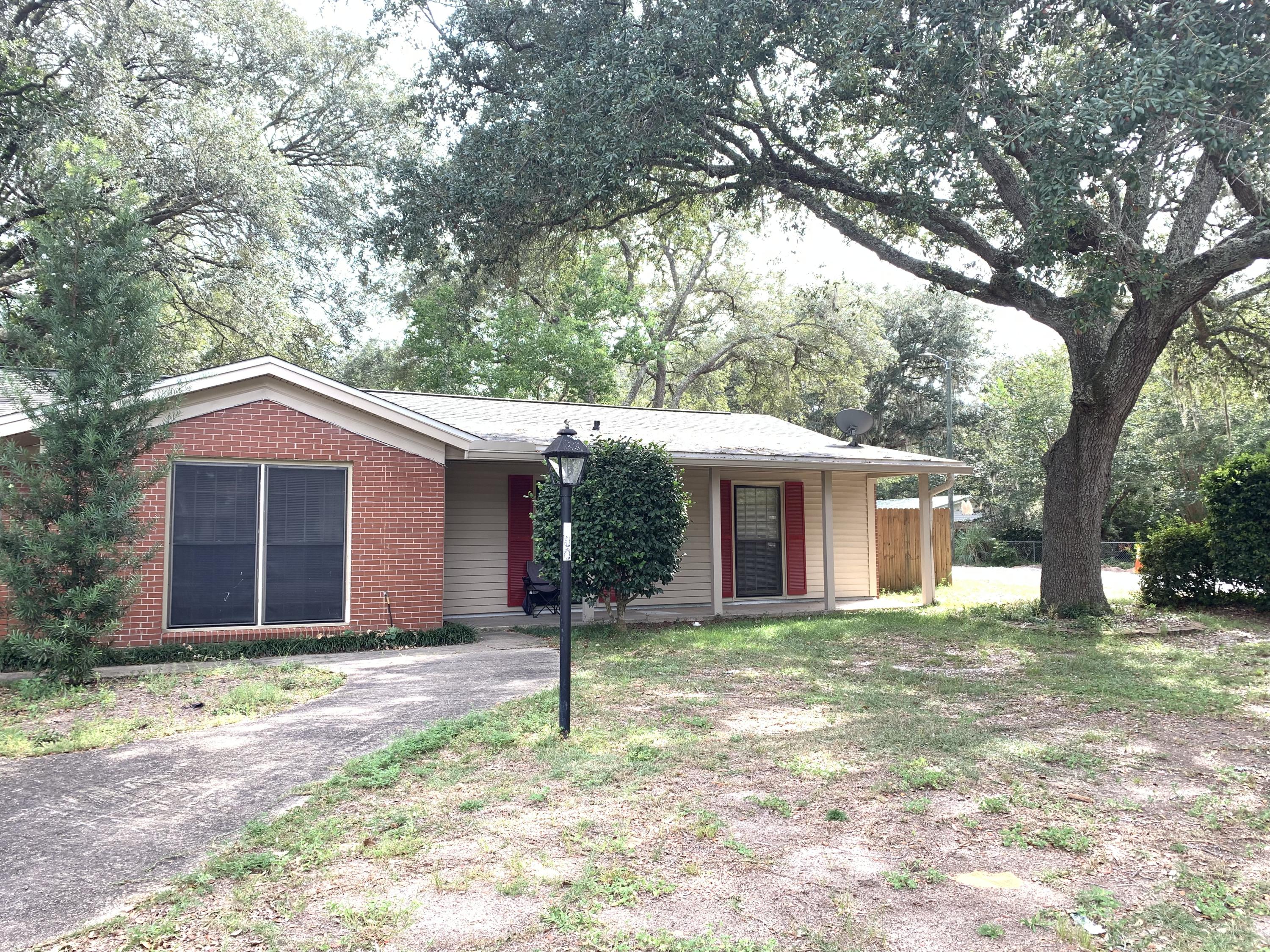 This lovely home is situated on a corner lot with mature oak trees. The garage was converted into a comfortable den with wood burning fireplace. The master bathroom has been updated with a tile shower and newer vanities. The master bedroom is very spacious and has crown molding. The roof is 2015, new vinyl siding 2015, and a newer water heater as well. The fenced backyard has a double gate with a covered RV parking pad that was added in 2015 as well. The shed conveys as is.