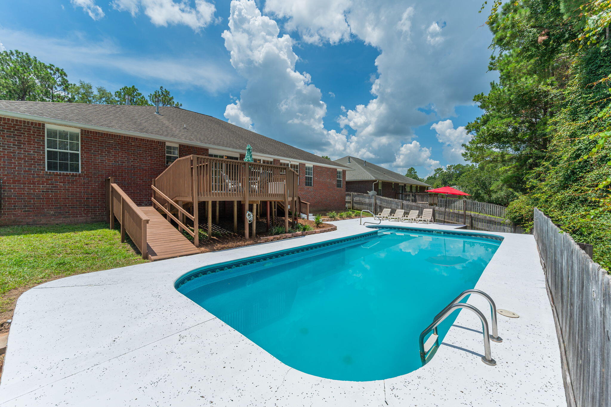LARGE HOME, LARGE POOL-South Crestview! If you are looking for a turn-key property @ a great price within 20 mins to 7SFG/30 mins to Eglin AFB-this is it. Included in the sales price come these value added benefits to the next owner: NEW ROOF prior to closing, $12k credit to Buyer Closing Costs, & paid off solar panels. Additionally, several other big ticket items have already been updated(see feature sheet). Floorplan highlights: 4 br + 2 family rooms + 3 full bathrooms + formal dining + massive kitchen. All you need to do is pack your pool floaties because this backyard space is sure to be your gathering spot for years to come! 16x40 saltwater pool, extended concrete decking, and large deck w/access ramp all back up to timberland property, offering privacy and quiet to the rear.