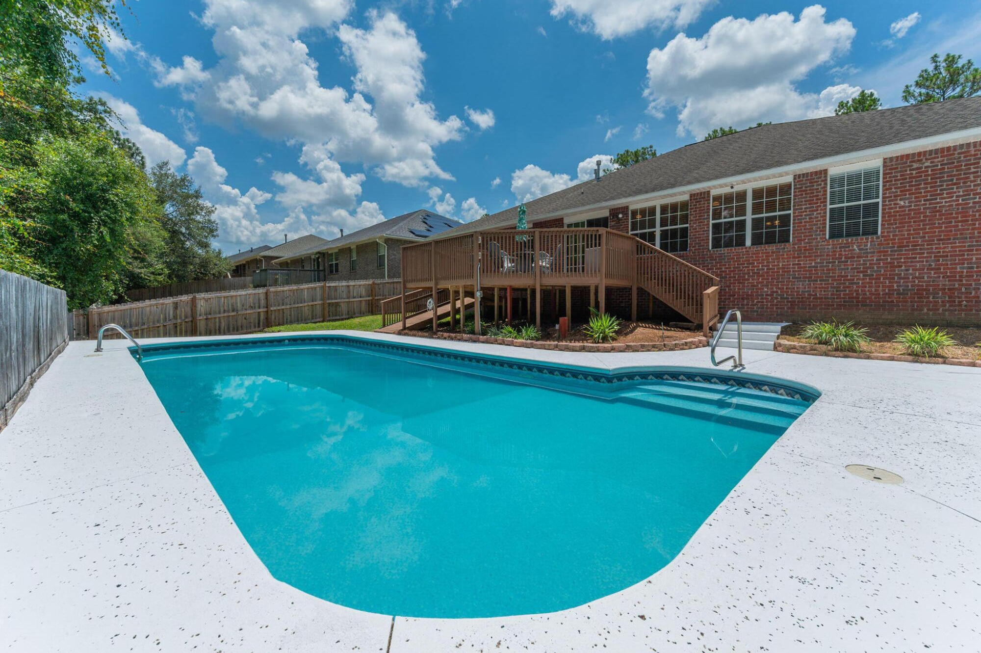 LARGE HOME, LARGE POOL-South Crestview! If you are looking for a turn-key property @ a great price within 20 mins to 7SFG/30 mins to Eglin AFB-this is it. Included in the sales price come these value added benefits to the next owner: NEW ROOF prior to closing, $12k credit to Buyer Closing Costs, & paid off solar panels. Additionally, several other big ticket items have already been updated(see feature sheet). Floorplan highlights: 4 br + 2 family rooms + 3 full bathrooms + formal dining + massive kitchen. All you need to do is pack your pool floaties because this backyard space is sure to be your gathering spot for years to come! 16x40 saltwater pool, extended concrete decking, and large deck w/access ramp all back up to timberland property, offering privacy and quiet to the rear.
