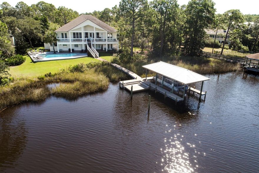 This 4426 sq ft water front home on Mack Bayou is a must see. The home features an open floor plan with Travertine flooring throughout the main living area upstairs featuring a gas fireplace, built in book shelf's and vaulted 14' ceilings. The gourmet kitchen is presented with stainless steel appliances, granite counter tops, maple cabinets, cathedral ceilings & a large breakfast area, formal dining room, den/study, on the opposite side there is the guest bath and 2 bedrooms with 11' ceilings, one with a private bath room. There are multiple private balconies on the front and rear of the home. The master features a custom stone shower, whirlpool tub & plenty of closet space with great views of the Bayou through the french doors leading out to the huge covered back porch.