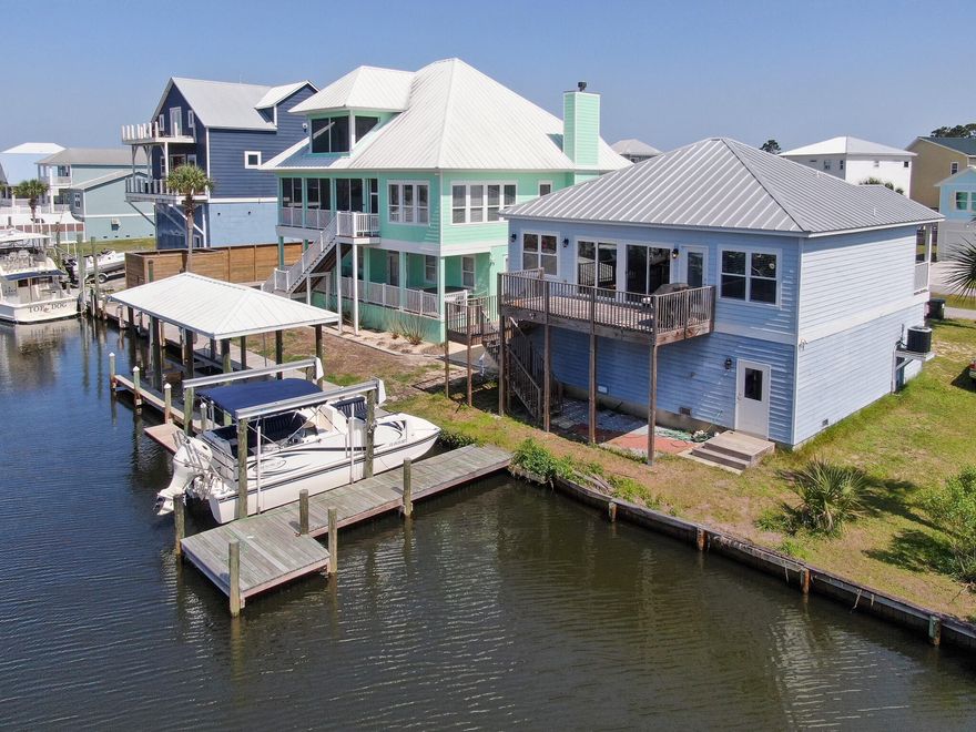 Waterfront living is calling your name! Custom built home with 50ft of canal waterfront and private boat dock and lift. Be in the gulf in just a few minutes. Open concept living, all on the second floor. Ground floor is finished, two car garage for all of your storage needs. Short term rentals are allowed in this area. With the hall bunks, this home could sleep 8! Call today!
