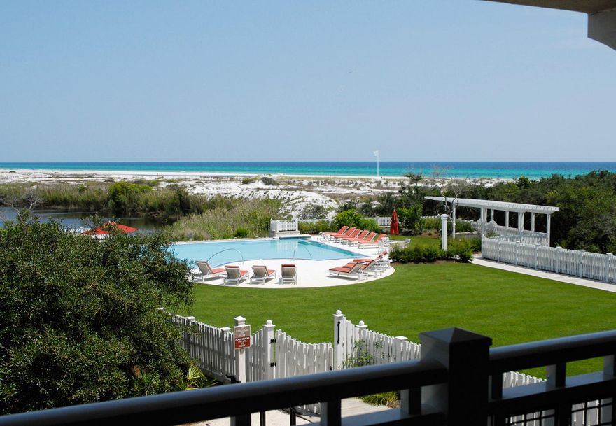 Just steps to the Beach, this 3-bedroom, 3.5 bathroom townhouse style condo features gulf, lake and pool views!  Inside you will find gorgeous hardwood floors in the kitchen, dining and living areas. Gourmet kitchen, with granite countertops, stainless steel appliances, and a Viking gas range. Master bedroom is located on the first floor with private bathroom with a shower and a spa tub, and a private screened porch. Two guest rooms are located on the second floor both with ensuites. The second-floor balcony offers outstanding views and a great place to relax and enjoy.  You will find plenty of room for storage in the attached garage!  Enjoy the private and beautiful community pool nearby or take a quick walk over to the beach and enjoy the GULF.