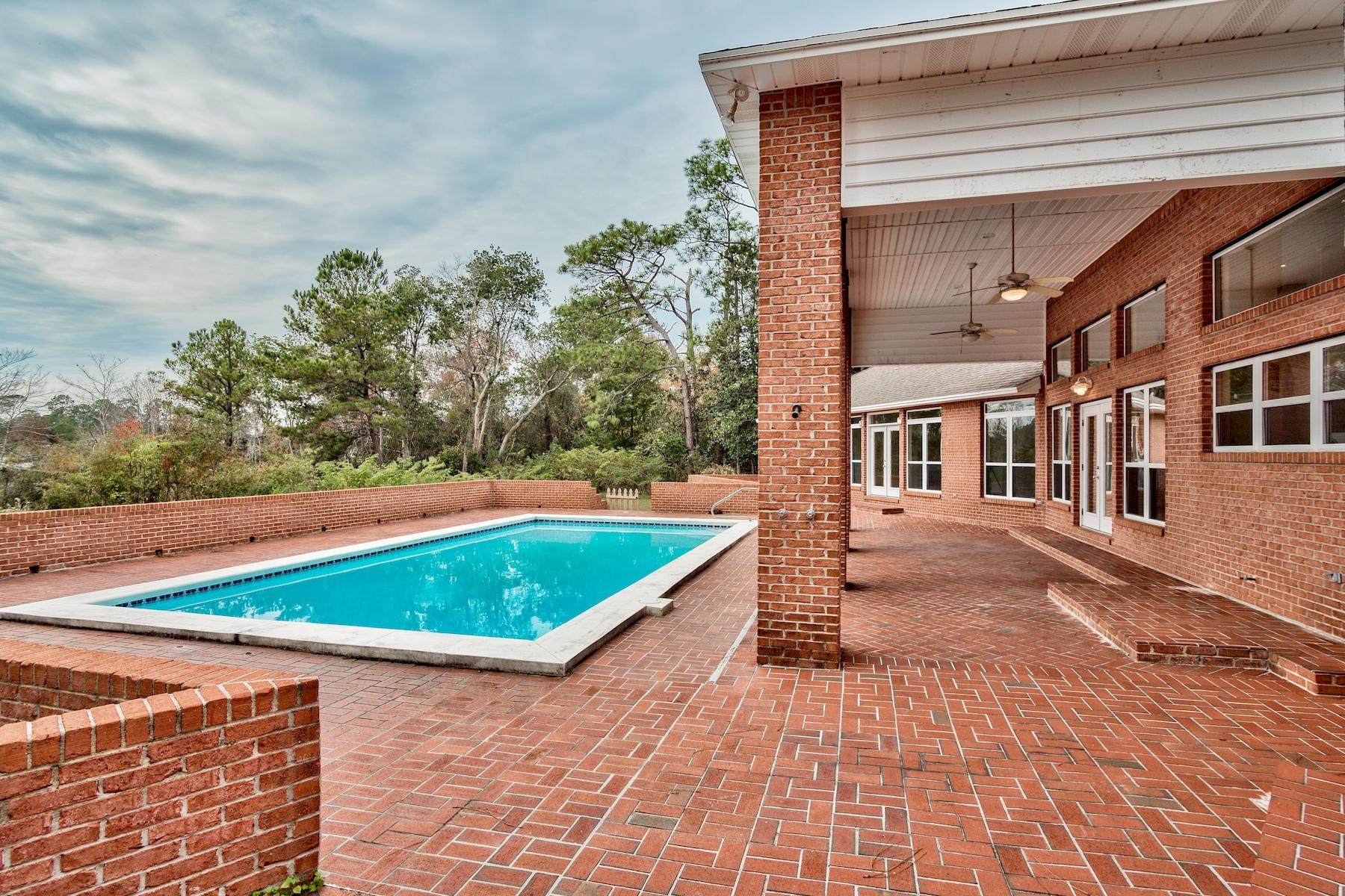This house is all about the LAKE LIFE! Sitting on the largest lot on Back Lake this home, complete with private pool, is a lake lovers paradise. Boating, Fishing, Kayaking and more all from your very own back yard! When your not on the lake enjoy a private 8ft deep in-ground pool with diving board, and open concept floorplan perfect for entertaining guests or soaking in the beautiful views! Two large living areas with vaulted ceilings and dual gas fireplaces will keep you and your guests happy all year round. This ranch style floorplan optimizes lake living with access to the grounds from every bedroom. The 1500 sq. ft. dock can accommodate any size motor boat with 8ft deep water.