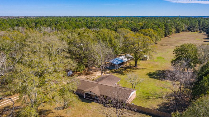 Beautiful 4 bedroom 2 bath on over 6 acres country get away without having to sacrifice the easy commute to the local bases, beaches, and shopping centers. Property has a 30x80 Pole barn along with the barn/shop. There is also an additional 24x75 lean to barn for additional equipment storage. The property is fenced and crossed fenced so bring your horses and other farm animals. As you step you will right away notice the ample room for entertaining friends and family with the large living room, dining area and conveniently open to the kitchen. Kitchen boasts ample counter and cabinet space for all your cooking needs. There is even a Florida room for additional square footage to be used as an office, gym or toy room! Enjoy your morning coffee out on