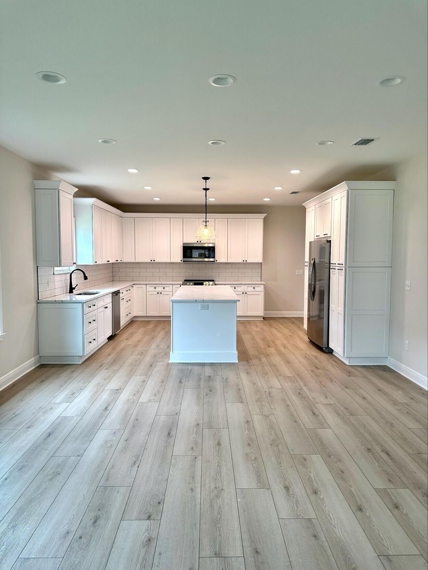 Welcome to Summerfell at Old Town, Destin's newest development! This stunning property boasts 2620 square feet of luxurious living space, with 5 spacious bedrooms and 3 beautifully appointed bathrooms. As you step inside, you'll be greeted by an open floor plan that seamlessly flows from room to room. The living room features stunning beamed ceilings and beautiful runmill isle flooring throughout, creating an elegant and sophisticated ambiance. The kitchen is a chef's dream, complete with a stylish kitchen island with pendants, sleek quartz countertops, and stainless steel appliances. You'll love cooking and entertaining in this space, which is perfect for hosting family and friends. The bedrooms are spacious and well-appointed, with large closets providing plenty of storage space.