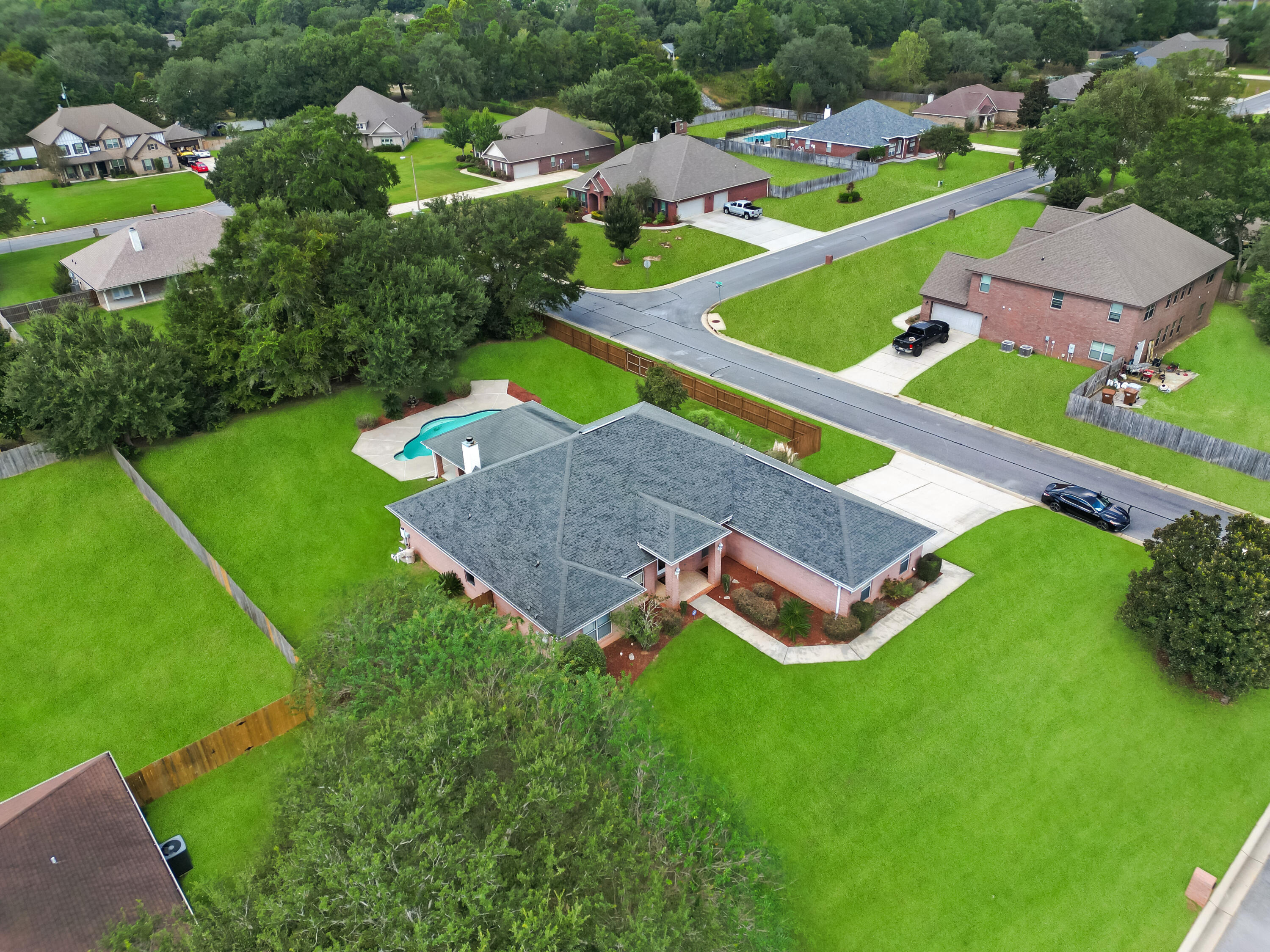 OPEN HOUSE SATURDAY 10/4, 8-11 AM - Welcome to Cottonwood, a gated community in Milton, FL. This all-brick pool home on a 0.5+ acre corner lot offers comfort and style. Enjoy a 3-car side-entry garage, full gutters, and vaulted great room with fireplace. Office w/ French doors, formal dining, and tile in wet areas. Kitchen features granite island, GE Profile cooktop, wall oven, microwave, deep sink, pantry, and glass-tile backsplash. Sunny breakfast nook overlooks pool. Spacious primary suite has tray ceiling, sitting area, soaking tub, dual vanities, shower, and walk-in. 3 guest bedrooms share 2 full baths. Covered lanai, grill pad, gunite pool w/ in-pool seating, fenced yard, hot tub pad, new roof (in progress), HVAC 2016, new water heater. Schedule your private tour today.