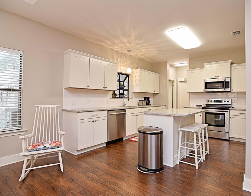 Exquisitely updated, 3br/2ba, lake front home in desirable Bluewater Bay. Marble tile and updated light fixtures immediately welcome you upon entering. Updated features include hardwood flooring, updated cabinetry, tall baseboards, subway tile and so much more! Kitchen has been opened up allowing for easy access to the dining area, as well as, a lovely view of the water. Living room is open and accented with lovely tiled corner gas fireplace Kitchen sports beautiful granite countertops, white shaker cabinets, custom pendant lighting, all stainless appliances, and