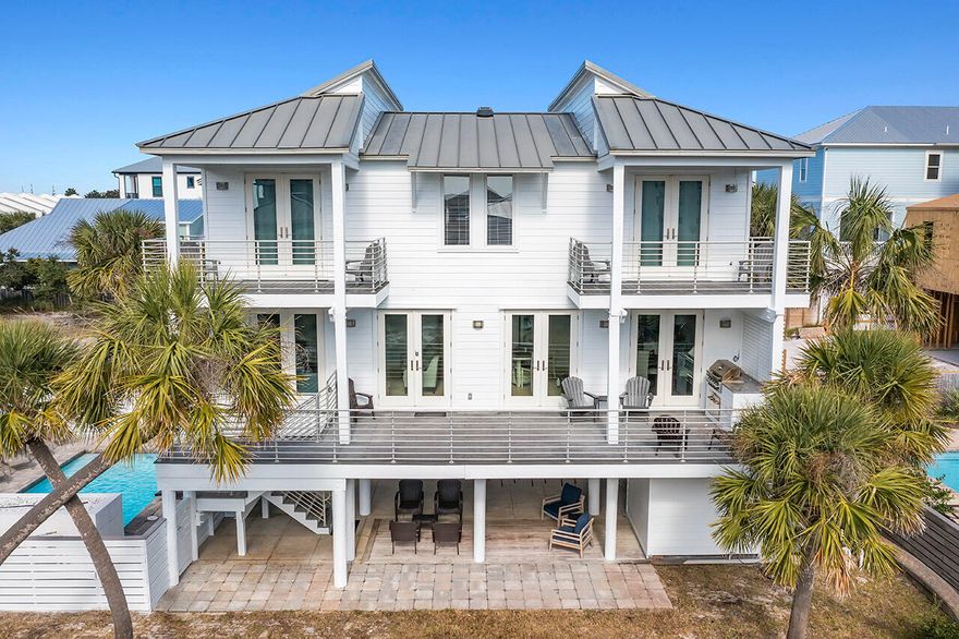 Located in a gated community in a quiet area of Miramar Beach, this coastal-style estate is just a short 1 minute walk to your deeded beach access. An abundance of balcony space along with its open living and dining area make this home a great place for gathering and taking in the gorgeous Gulf views - which can be seen from 2 bedrooms as well as the living and dining areas! Outside, you'll be greeted with a private pool with a relaxing waterfall, and ample lounging. The ground floor offers shaded space with patio seating, an outdoor bar, and flat-screen TV, create the perfect environment for outdoor entertaining. The first floor boasts a cozy living room with plush furnishings and a gas-powered fireplace.