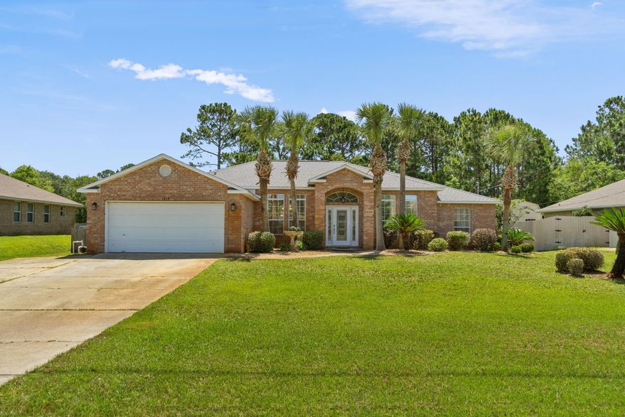 *Sellers will be paying off the solar panels in full at closing!* Welcome home to this gorgeous all brick Holley by the Sea 4 bedroom home with a formal dining/flex room close to Navarre's gorgeous beaches in the popular neighborhood of Holley by the Sea. Featuring a multi-million dollar recreation center (see photos!) you'll love all the amazing amenities for only $450/year. Pull up into the driveway of this lovely home and you'll appreciate the tasteful landscaping with palm trees and the gorgeous glass front door. Inside you'll appreciate tile flooring throughout (no carpet!) and even wood look tile. The spacious living room features a fireplace, and the formal dining room is currently being used as a playroom. The kitchen is complete with a granite counter functional island, stainless