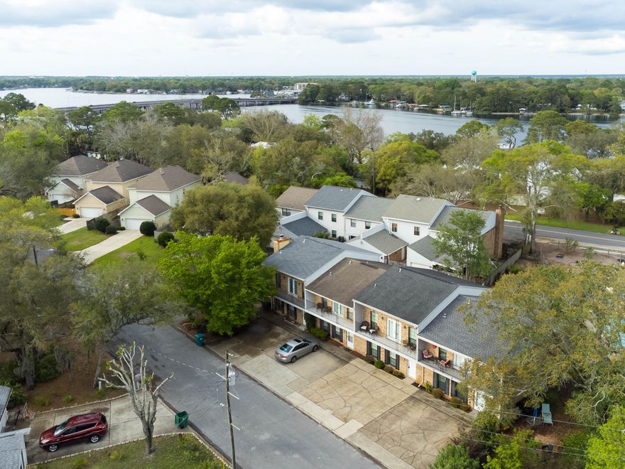 Amazing new price! Location, location, location! Hidden gem (3 Bd/2.5 Ba TH) nestled in quaint Cinco Bayou. Shopping, restaurants, elementary school nearby - quick walk to shaded bayou front park, around the corner from Glenwood Park Nature Trail AND only minutes to the Gulf beaches. Tucked away on a quiet street just off Yacht Club Dr.  Great floorplan with interior laundry. Brick & hardi-plank siding, exterior storage room off the cozy fenced rear yard w/water feature & brand new fencing. 20'+ wide balcony off master bedroom. Beautifully maintained: new roof in 2015, high eff. AC in 2017 (w/smart therm.), Pex plumbing 2015, impact windows 2017, new impact balcony doors 2022, DW 2017.  2'' blinds throughout, huge walk-in closet. Home warranty included! You'll be glad you saw this one!