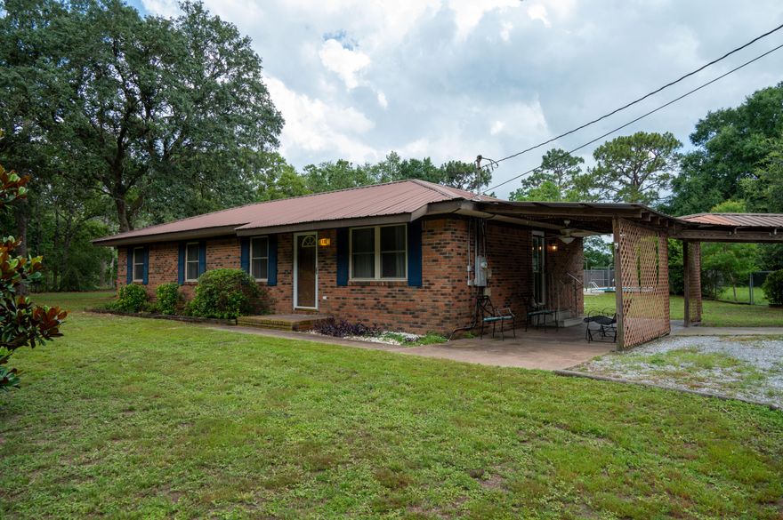 Charming Homestead Retreat on 1.06 Acres with Pool & Guest Studio. NO HOA.South of I-10 and a convenient commute to Duke Field, 7th Group, Camp Rudder and Eglin AFB, this 1.06-acre lot is truly one of a kind.Quaint and charming with a fence protected in-ground pool, fire pit, chicken coop, plus a separate ''dog run'' area that can be used as a homestead garden, this property could be your oasis to enjoy those peaceful Florida summer evenings. Adorable main house with 4 bedrooms, 2 baths.Fresh paint, laminate flooring throughout, updated eat-in kitchen with brand-new stainless-steel appliances, granite countertops, and white tile backsplash. Stroll under the covered walkway to the studio perfect for family visits or potential rental income.Well-pump and septic tank operable.