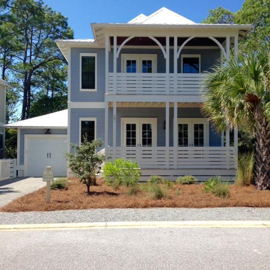 REDUCED $30,000! The owners are serious! Curb appeal with loads of extras! This home has it all. Windows and French doors throughout for great natural light, 4 bedrooms, 3.5 baths, hardwood floors, open floor plan, and two outdoor covered porches for lounging or entertaining. The home offers two master suites, custom tile in each bathroom shower including glass shower doors. The kitchen offers granite counter tops, glass back splash, stainless steal appliances and white cabinetry. Freshly painted with ten foot ceilings and crown molding. Community pool and club house with shopping, restaurants, and beach access within walking distance. This location is ideal for a permanent or short term home. Beautiful lake view for privacy in the rear of home. Enjoying making those beach memories today!