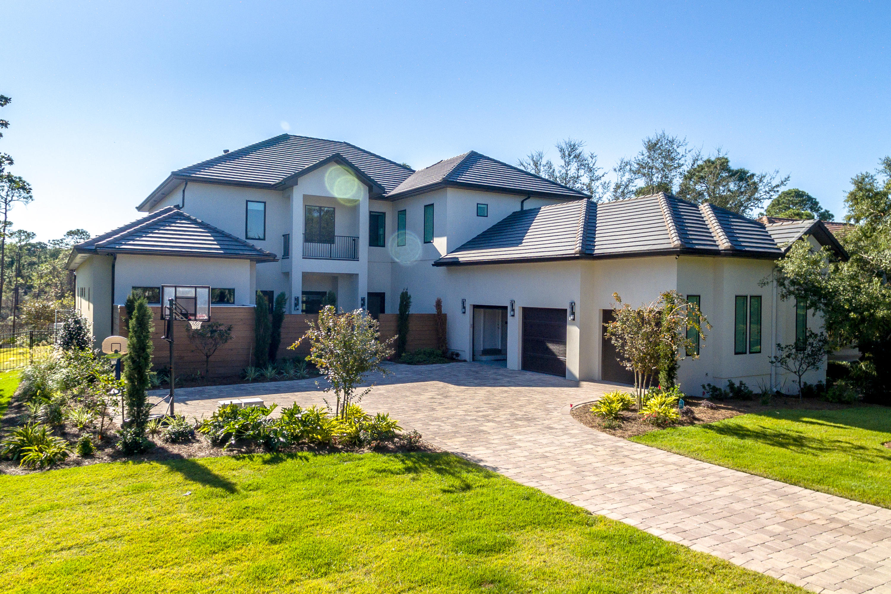 Experience luxury living in this six bedroom, six-and-a-half bathroom contemporary masterpiece with 9300 sq ft under roof. The exterior epitomizes fine craftsmanship with decidedly beautiful details including cypress fencing, immaculate landscaping, and a serenity patio that features dual fountains and seating for six. Open the 6-foot by 8-foot custom made front-door and step into 6,400 square feet of sheer bliss. Two-hundred year-old hickory, oak, and maple reclaimed wood flooring transcends throughout the two-story home.Two-hundred year-old hickory, oak, and maple reclaimed wood flooring transcends throughout the two-story home. A double living room provides ample space for large, family-living.