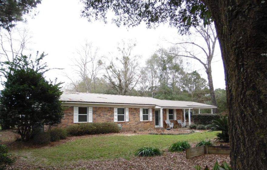 Come check out this spacious 3 bed, 2 full bath, 1 story brick home set out in the country! This home sits on 1 acre surrounded by peacefulness & privacy! As you enter into this home you come into the large living room, which has both a formal dining room & kitchen attached. There is hardwood flooring in the living room, tile flooring in kitchen, dining room, & bathrooms. All of the bedrooms are carpeted. The extensive master bedroom suite which fits king size furniture features a sitting area, two walk-in closets, & an immaculate master bath. The master bath has double vanities, a Jacuzzi, & separate shower. There is a screened in porch for outdoor living space. The yard includes a small shed, a dog kennel, & a 20x36 barn on a concrete slab. Call today for your private tour!