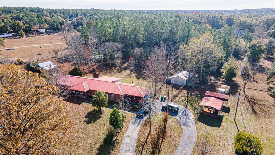 Buy your horses a home!! And a 3 bdrm home with an office space that could be used as a 4th bdrm. WAIT TILL YOU SEE THE SIZE OF THE MASTER BDRM!!!  All fenced in for your fur babies. Large area on the back of the house could be a nice family room.  There are 3 horse stalls (needs love), a pole barn,and a very large workshop with electricity! This home has so much to offer. The green house needs love as well. As you pull into the driveway, there are brick pillars with metal horses on top to greet you. Just open the gate and drive on in to the left driveway. The home sits back off the road for privacy. Kitchen and baths are good size and somewhat updated. A private well gives fresh water that tastes great right out of the faucet. Peace and quiet property awaits yo
