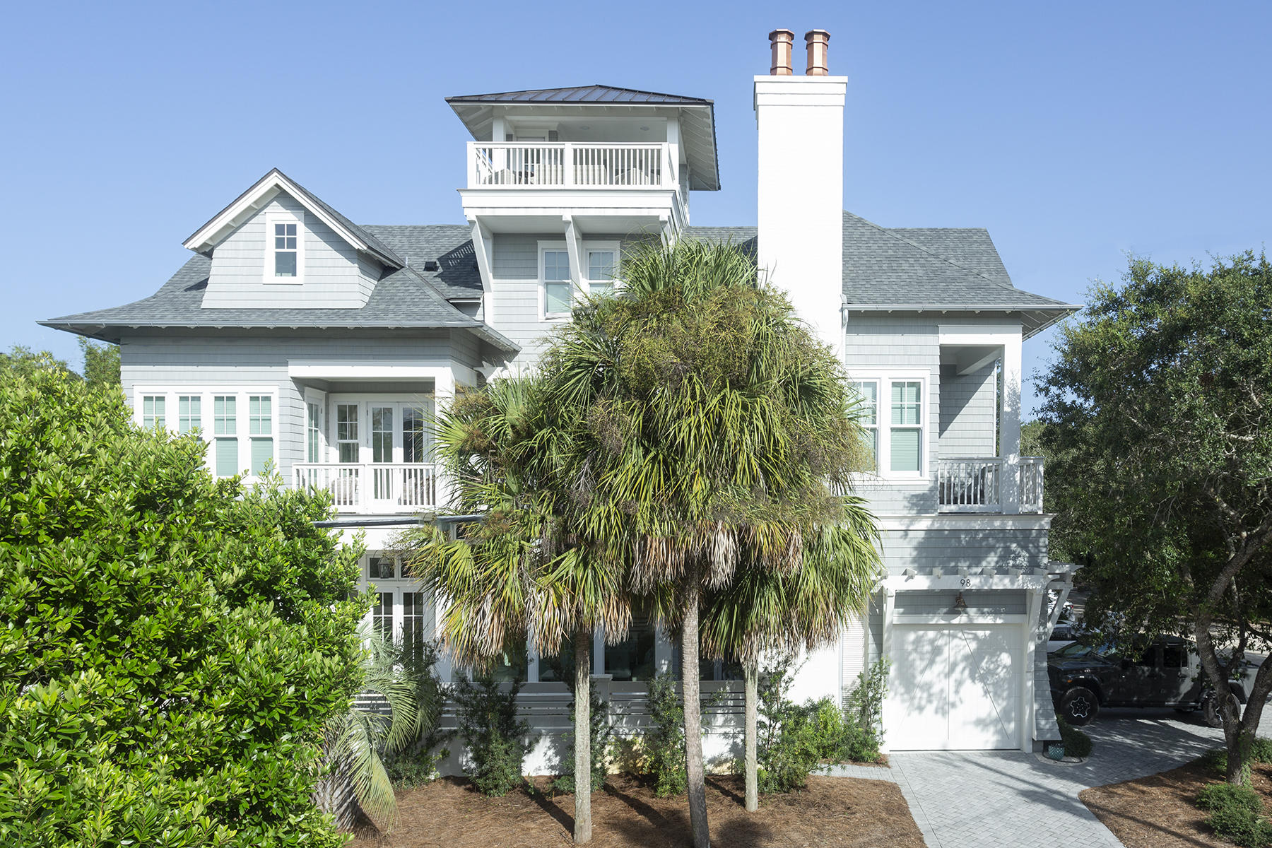 This beautiful four-story home is one block from both Seaside and the beach. The home's soft grey hardy board exterior, flickering gas lights, and arched entryway enhances this luxurious but cozy property. The foyer opens to a spacious open living area filled with natural light from the large retracting glass doors and floor to ceiling windows. Beautiful exposed beams and pecky cypress ceilings showcase three chandeliers throughout the area. The large open living space features comfortable furnishings in pastel blue-grey and washed wood accents and gives way to an alcove for the large, rustic dining table with seats for twelve. Beautiful cabinetry adorns the kitchen and disguises the dishwasher and refrigerator for a clean sleek look. A Thermador gas stove, porcelain farm sink, walk in pantry, and large island pulls this kitchen together perfectly. Opening the retractable glass doors exposes the indoor living space to the covered, outdoor lounge area with a comfortable sofa and chairs and an inviting fireplace. Adjacent lies the saltwater pool and outdoor kitchen and dining area with a turf grass yard and outdoor shower. The main floor also features a bedroom with a king bed and ensuite. The second floor opens to a private office space, a king bedroom suite, a queen suite, and a gathering area with wet bar leading to the owner's suite. The owner's suite features a beautiful king bed, fireplace, and large chandelier in the center of a vaulted ceiling. The bath features a walk-in closet, double vanity, soaker tub, and large shower. The third-floor hosts two bunk rooms, both with three twin beds and one double with one room featuring an added trundle. Both rooms have full baths, and the center living area features a wet bar and media area. The pinnacle of the house is the fourth floor viewing tower with panoramic views - great for viewing amazing sunsets over the Gulf. 

Modern technology enables remote access for heating and cooling, security cameras, entry, and access through the garage, and Sonos media system. Additionally, the first and second floors both feature a washer and dryer, an elevator services the lower three floors, and the in-home vacuum system makes cleaning up sand after a beach day quick and simple.


***Buyer is responsible for personally verifying details about this property. Any information contained in this listing is believed to be accurate but is not guaranteed.***
