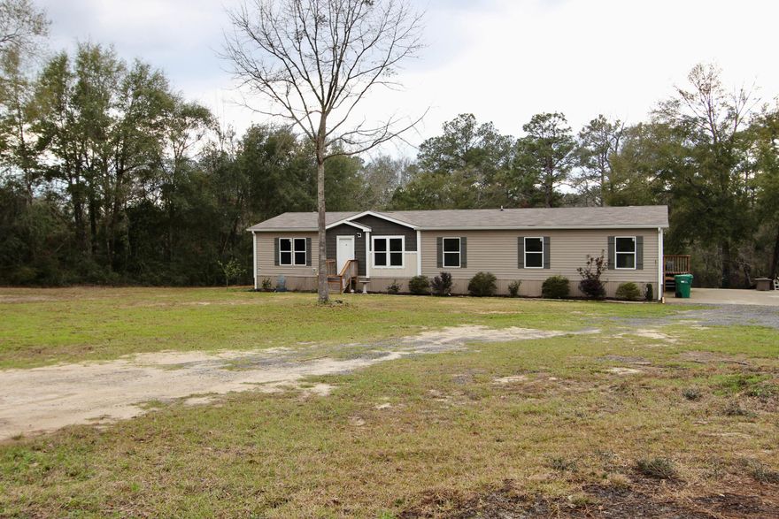 Seller Offering $5,000 towards closing cost with acceptable offer. Welcome to this charming 4-bedroom, 3-bath home nestled on 1.7 acres with tranquil pond water frontage, offering a peaceful, nature-filled retreat. With 2,016 sq. ft. of spacious living, this home is perfect for families seeking comfort and serenity. The rustic barn door accents throughout the home provide a warm, inviting atmosphere that blends modern living with country charm.Step outside and enjoy the stunning water views, perfect for relaxing or outdoor activities. Inside, you'll appreciate the thoughtful details, including a whole-house filtration system with UV light technology--ensuring your water is free of sediment and bacteria for pure, clean water from the fresh deep water well. With ample room, a great layout, and a serene location, this property is a true gem