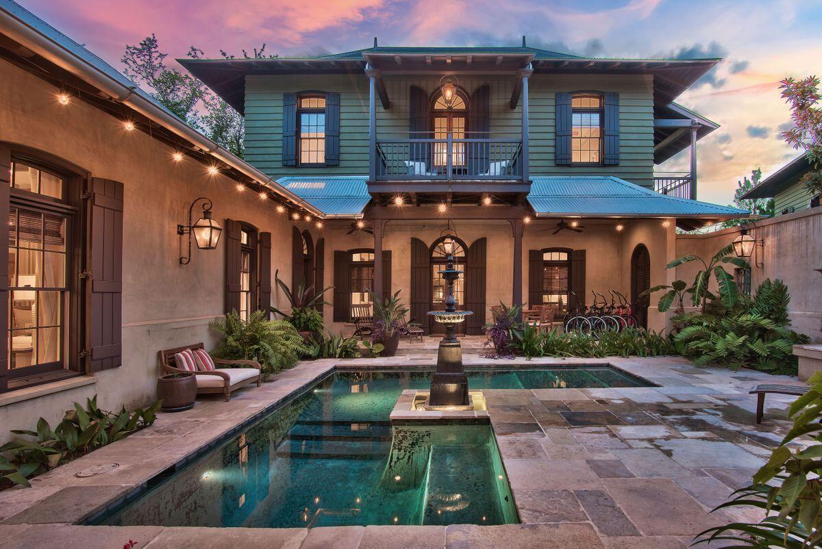 Stunning Colonial home on spacious homesite featured in Veranda Magazine, this extraordinary British Colonial style home wasthoughtfully designed by Charrette Design Group. Situated on one of the largest, mostprivate homesites in Rosemary Beach this 4,584 sq.ft. complex is brimming with bespoke architectural features. Antique French limestone floors, custom mahogany woodwork and antiqued plaster walls lend the feeling of ''Old World'' charm. Beneath the darkwood beams in the living room, put your feet up in front of the cosy Isokern fireplace with its custom mantel. Natural elements and stylish transoms create an elegant yet casual touch throughout the property.