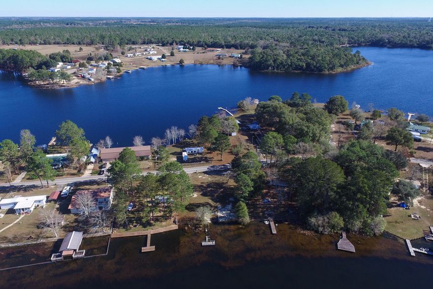 ISLAND FRONT PARADISE AWAITS! This waterfront lot faces west (beautiful sunsets) and is situated on exclusive Paradise Island; which is surrounded by PRIVATE KING'S LAKE... that adjoins Lake Holley. Huge savings for the buyer because septic, water, and electric are already in place. There is a partial seawall and partial pier. Owner says pier pillars are structurally sound. Planks will need TLC. Owners removed a mobile home off the property and installed a brand new boat slip. There is a large ginger plant and bamboo growing on the property. The lake is famous for its record size bass, large variety of bream, and those fun to catch perch. Sunset King's Lake Fireworks displays are easily viewed from this lot. Bring an offer and you can live on beautiful Paradise Island.