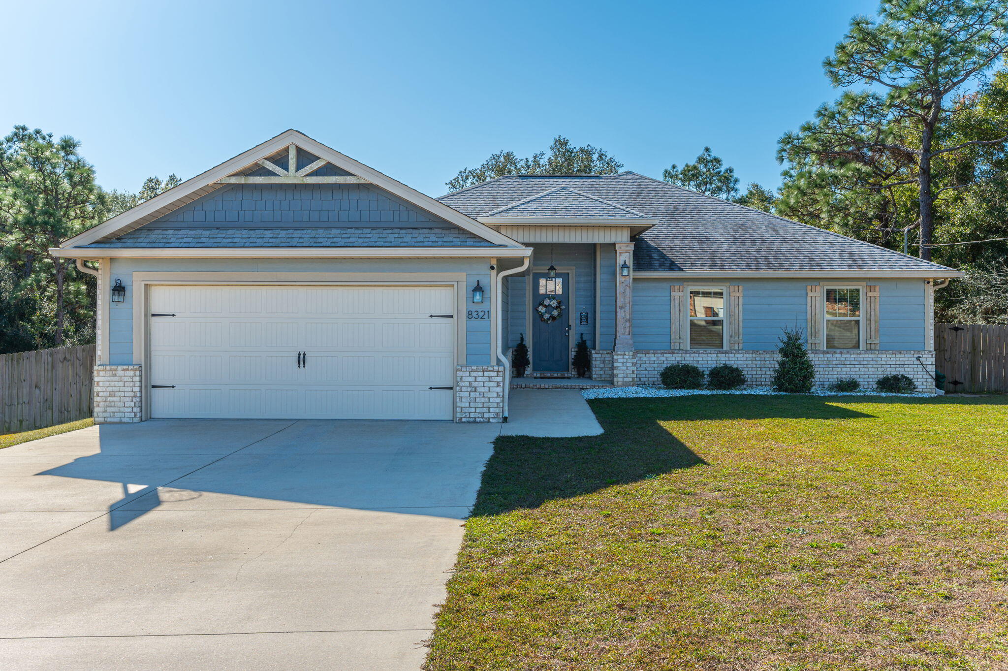 Show-stopper, custombuilt brick home. Spacious open floorplan, large bedrooms, and that extra 3rd bath for guests.  Bring the pets, there is no carpet in this home! Designer touches throughout, no space overlooked. Home showcases granite tops, soaring upper cabinets, soft close drawers and cabinets, designer fixtures, 8-foot custom designed doors, upgraded trim, 10 foot ceilings.   Master stuns with 3 closets, a substantially sized walk-in closet with custom shelving with two additional for an excess of storage.  Custom wainscotting, recessed lighting, trey ceiling and a ceiling fan.  Master bath is a dreamy retreat featuring classy tile in the 4 by 6 foot shower with glass doors, double vanities with custom granite, modern mirrors and fixtures, linen closet and a separate toilet room. Spacious pantry, large storage indoor laundry room, garage utility sink, 2.5 car garage, and anti-moisture A/C unit. Screened porch. Fully privacy fenced backyard with over a half acre to enjoy, and privacy all around; the property backs up to wooded areas. NO HOA