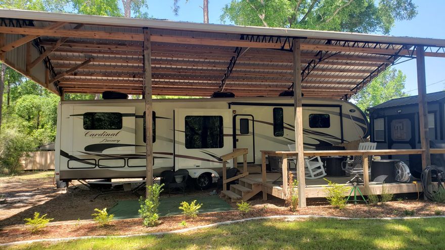 Picturesque & One of a Kind!~RV Retreat or Build your Dream Home! Not far from town & has everything to make you comfortable, Pole Barn covers a 42 ft RV & comes complete with a deck for chillin' on those summer nights. Included with property are 3 Large Storage Buildings -2 buildings complete with sheetrock finish & AC.  The one under the pole barn doubles as your laundry room ( washer /dryer hookups) The other can be used for a sitting room, sleeping quarters, whatever you desire.  The 3rd building is complete with a lean-to and can handle all  your other storage items.  Seller has cleared the trees around the buildings and driveway making it a beautiful landscaped entryway. The ideas for this property are endless! **NOT INCUDED, 2019 Forest River Cardinal 42 ft Camper for sale $52,000