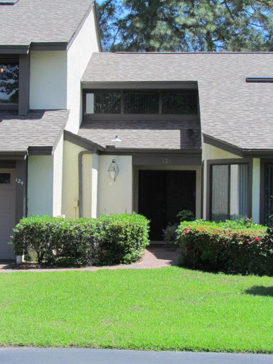 This modern townhouse in desirable Bluewater Bay is the epitome of the open, airy, bright home so in demand in this region.The interior is absolutely gorgeous and has been recently updated with high end details. The kitchen can only be described as state of the art, with plenty of counter space and all stainless kitchen appliances being updated just last year. Plenty of counter space, seating at the large island and an eating area make this a perfect kitchen for entertaining.You will love the recycled glass counters and the beautiful gourmet hood and backsplash. The flooring is stunning wood look tile, so no worries about scratches or water damage.The huge great room features a lovely fireplace and plenty of room for the largest furniture. The tongue & groove ceiling is straight out of a