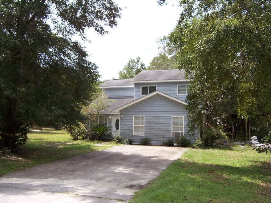 Tons of Potential! Fixer upper!! 2 Story Almost 2,000 sqft! Great location for this 4 bedroom with 2 mater suites 1 upstairs and 1 downs stairs large living/dining room with nice screened back porch and a big backyard on a corner lot in a great location. Located across from the Hammock Bay West entrance and close to parks and boat launches. Kitchen has been removed to the bare studs and will need to be replaced, so it will not qualify for traditional financing. Quiet neighborhood and no HOA fees.