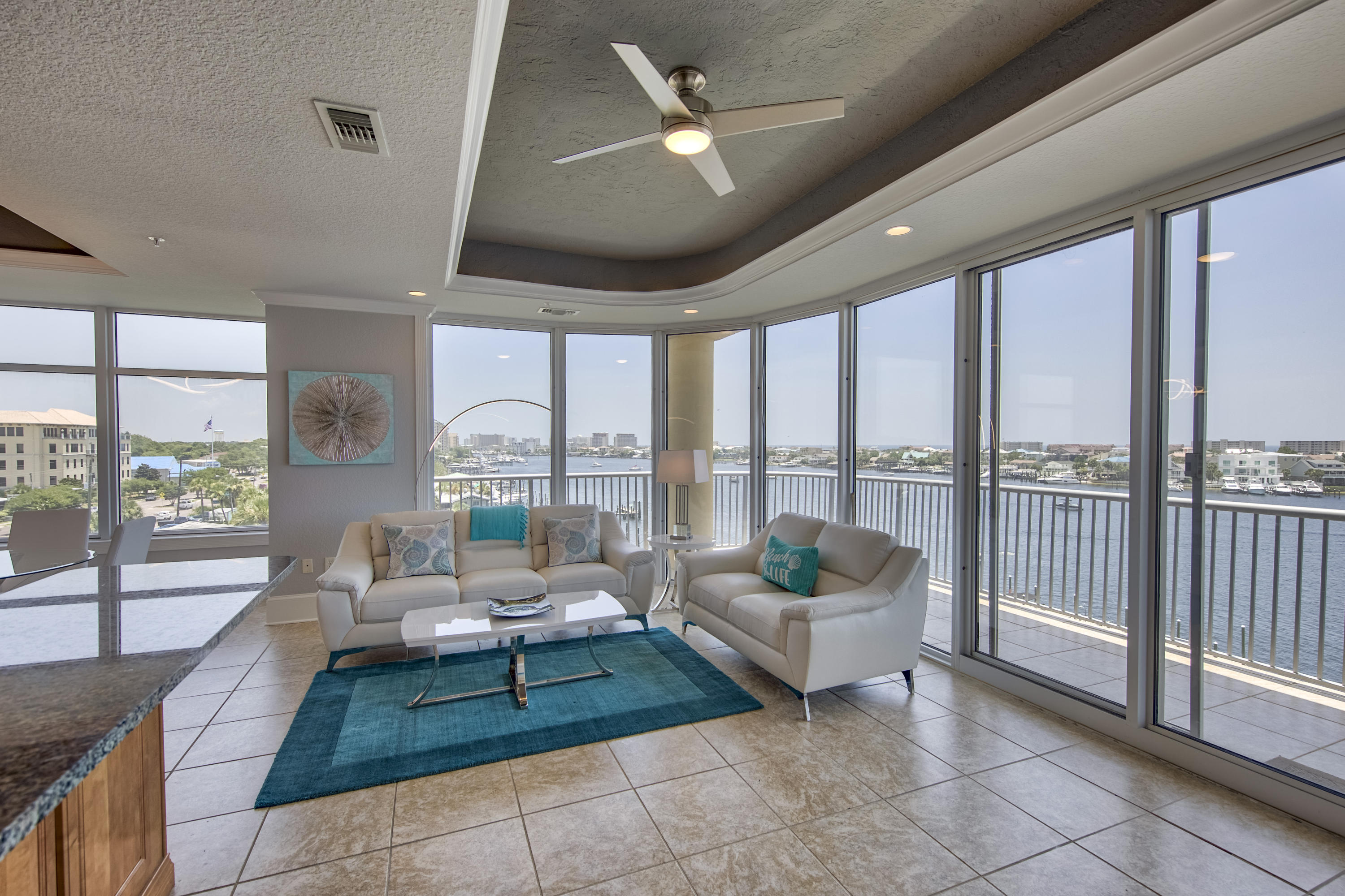 This elegant 2br/2bath condo sits right in the center of Destin Harbor. With three balconies and floor-to-ceiling wrap-around windows, this unit is a must see for anyone looking for fantastic sunset views. The large wraparound balcony provides spectacular views of the Harbor, Gulf of Mexico, and Destin's East Pass. Featuring 10' tray ceilings, custom cabinets, granite counters, tile floors in living areas, and wet bar. With only 12 units in Destin Harbor Place, you will enjoy privacy and exclusivity. Walking distance from great restaurants such as Marina Caf, Beauchamp's, and Harbor Docks. Amenities include private parking with 30 spaces for the 12 units, gated entry, exercise room, pool, and a ROOFTOP TERRACE! Weekly rentals are not allowed.