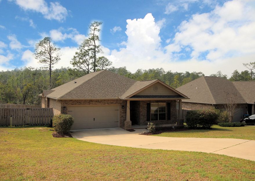 Conveniently located SOUTH OF I-10 this beautiful all brick Craftsman style home is in EXCELLENT condition.It is loaded with upgrades and extras like the gorgeous recessed panel maple cabinets and granite countertops in the kitchen, Bosch dishwasher, large ceramic tile floors in kitchen, dining room and all wet areas, and wood laminate flooring in the living room. Tray ceiling in the living room and box tray ceiling in the master bedroom. Garden tub and separate shower in the master bath. Dual vanity sinks with granite countertops there and in guest bath as well. Refrigerator with icemaker remains and also in the indoor laundry room the sellers are leaving a Samsung steam washer and dryer!! Raised deck to the rear overlooks your privacy fenced backyard and hot tub! Double car garage.