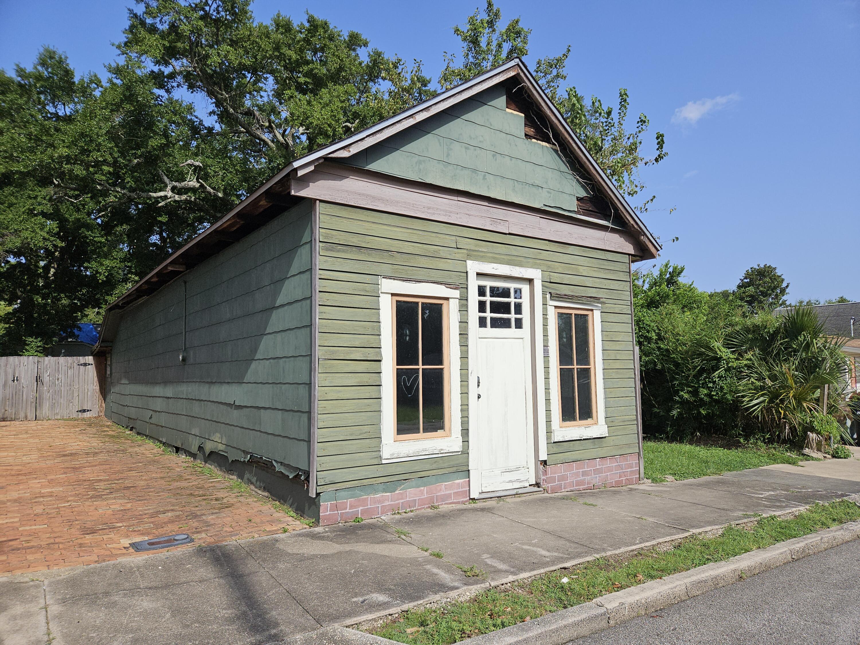 Lot in the Old East Hill neighborhood. Great value for a lot this close to Pensacola's thriving downtown! Located behind the Crown Plaza which was built on the site of the old historic train station, and the Bay Center (previously called the Civic Center).The existing structure has no value. Old East Hill is a historical preservation district, so building plans will have to be approved by the City of Pensacola Architectural Review Board (ARB) before obtaining building permits, and will require ARB approval for renovation or removal. The structure abuts the sidewalk, a unique feature that the ARB has stated adds to the historical value of the property. The lot is Zoned OEHC1, neighborhood commercial, and can be used for retail, office, or as a residence. Plenty of room to build a home at the back of the property, with an office on the street in the existing structure. L-shaped allows a private yard to put a swimming pool or garden. Several mature trees on the property for shade. There is a voluntary HOA association, Old East Hill Property Owners Association and the dues are $20 a year.