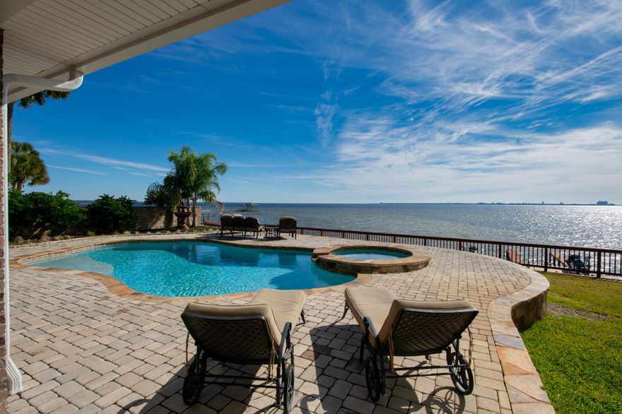 Incredible Estate Home with possibly the best view on Choctawhatchee Bay. Almost too many features to list, truly one of a kind. Home is situated on the Bluffs across the street from the 18th hole of Shalimar Pointe Golf Course. Remodeled and expanded in 2017 the home is gorgeous inside and out. Entry way opens to massive formal dining space and you're immersed in the panoramic views of Destin. Downstairs area has been perfected for entertaining offering dining seating for 20 guests, theater/flex space and tons of sitting area. Large en suite bedrooms all have breathtaking views of waterfront. Backyard offers a pool/spa, outdoor kitchen and plenty of entertainment space. Huge garage has been outfitted with 4 post car lift, built in pressure washer system and air compressor with plumbing. Home is offered furnished, including outdoor furniture, garage fixtures(lift, pressure washer, air compressor), televisions and audio equipment. Photos and wall decorations do not convey.