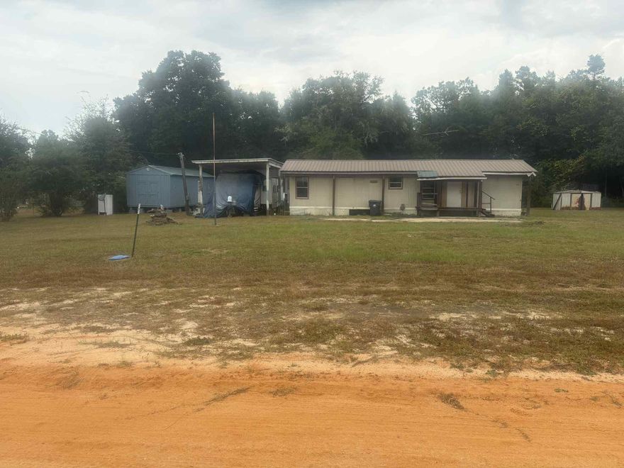 This property boasts a great deal, consisting of 2 lots and 3 storage units, with a well, city water, and septic tank. An RV hook up is provided. Moreover, one of the storage units has been framed up but not completed to use as a tiny home. Offering a potential source of extra income.